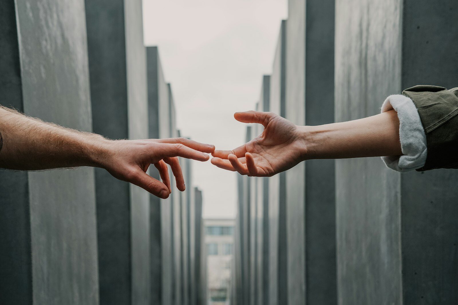 Two hands reaching toward each other — supportive, judgment-free addiction treatment in Martinsburg, WV