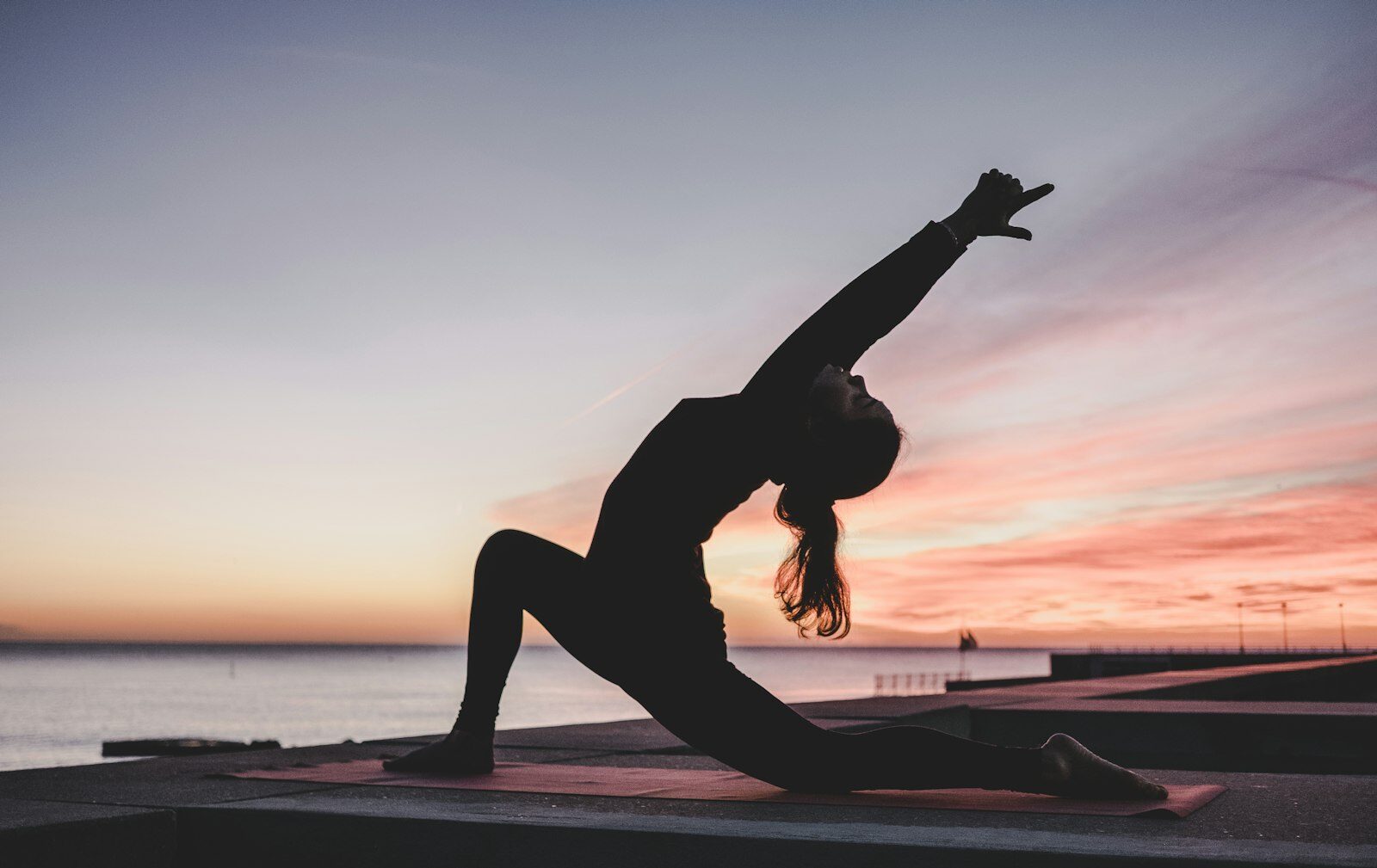 Person stretching peacefully at sunrise — a whole-person, wellness-focused approach to mental health